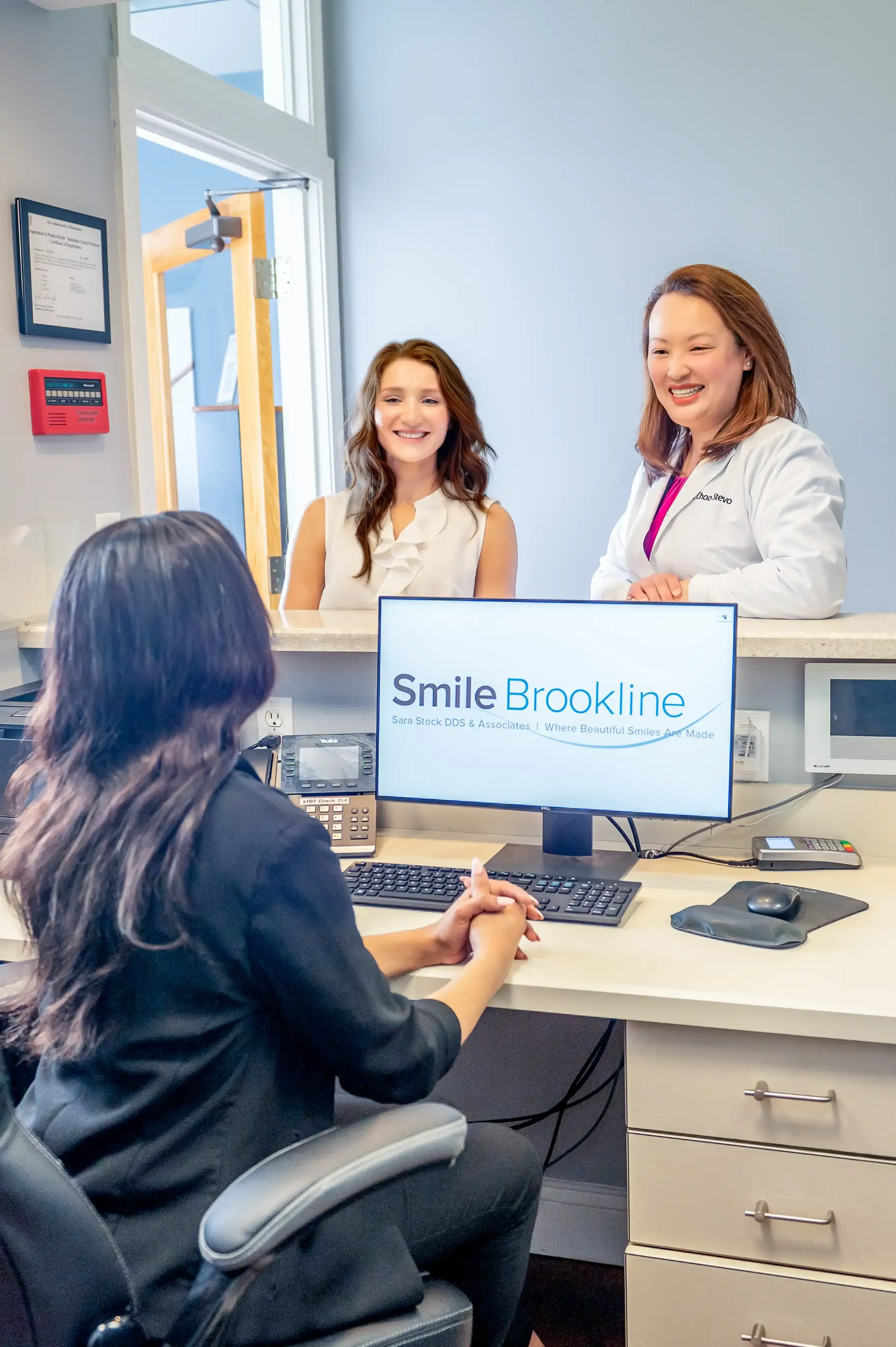 Front desk team booking new patient appointments at Smile Brookline Brookline Massachusetts