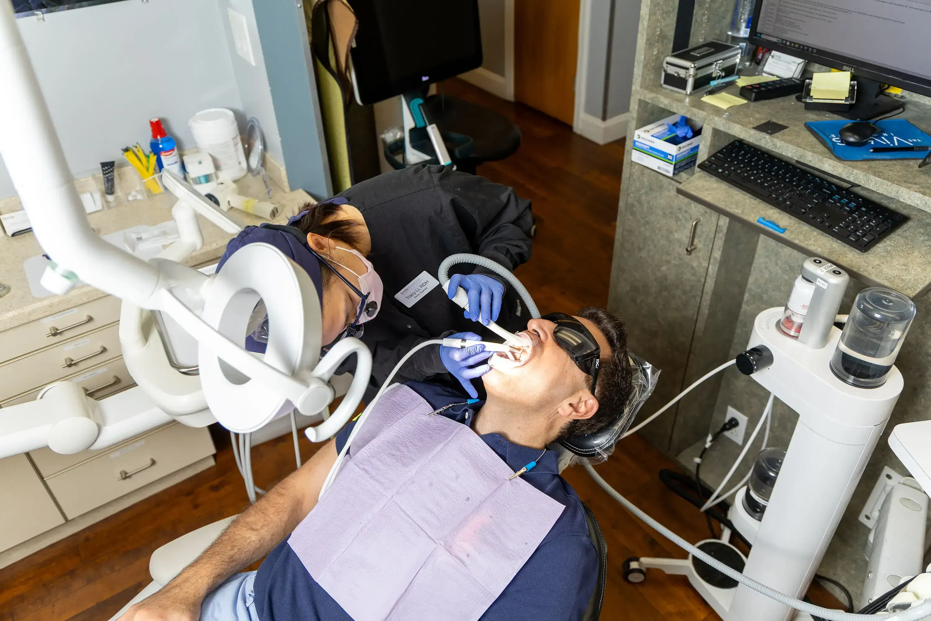Hygienist performing a dental cleaning in Brookline MA at Smile Brookline on Beacon Street