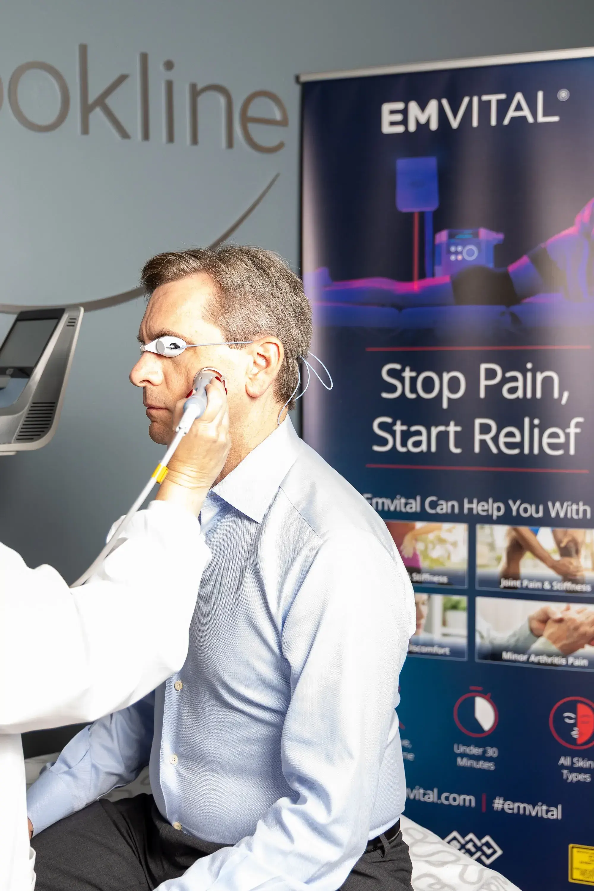 Patient describing morning jaw stiffness in front of the ear during a TMJ exam at Smile Brookline MA